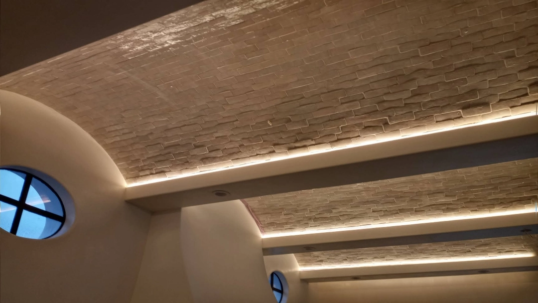Cove lighting illuminating several vaulted ceiling sections.